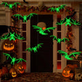 12-piece glowing skeleton bat swarm hanging across a Halloween porch