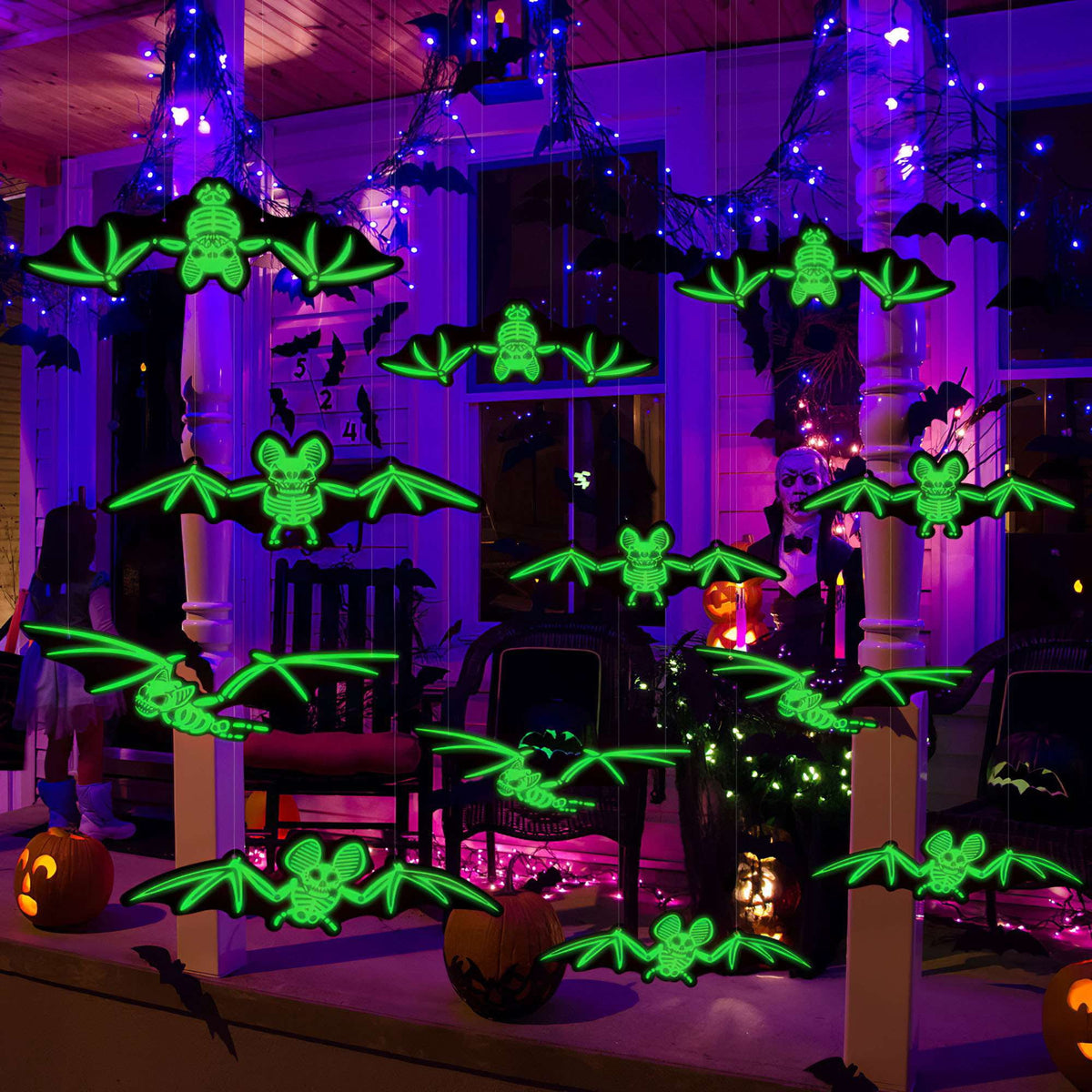 Glowing skeleton bats hanging across a purple-lit Halloween porch