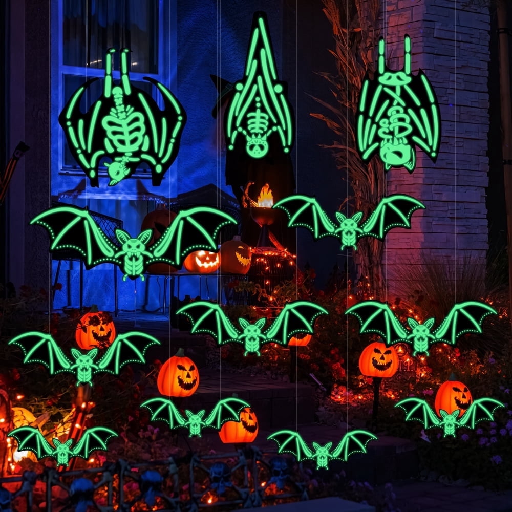 Glowing skeleton bats hanging in a Halloween yard display